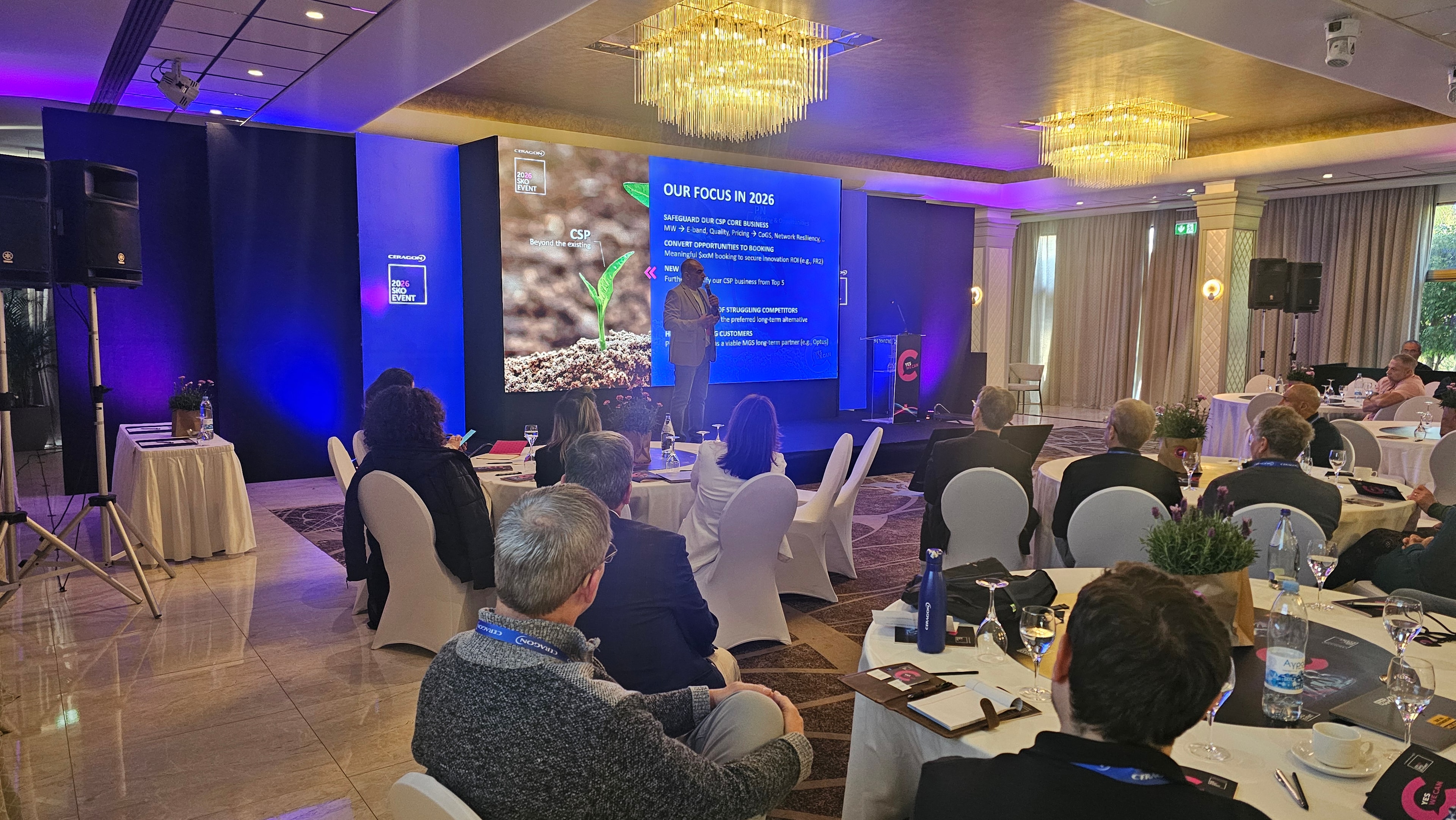 Conference presentation with stage lighting and audience seating