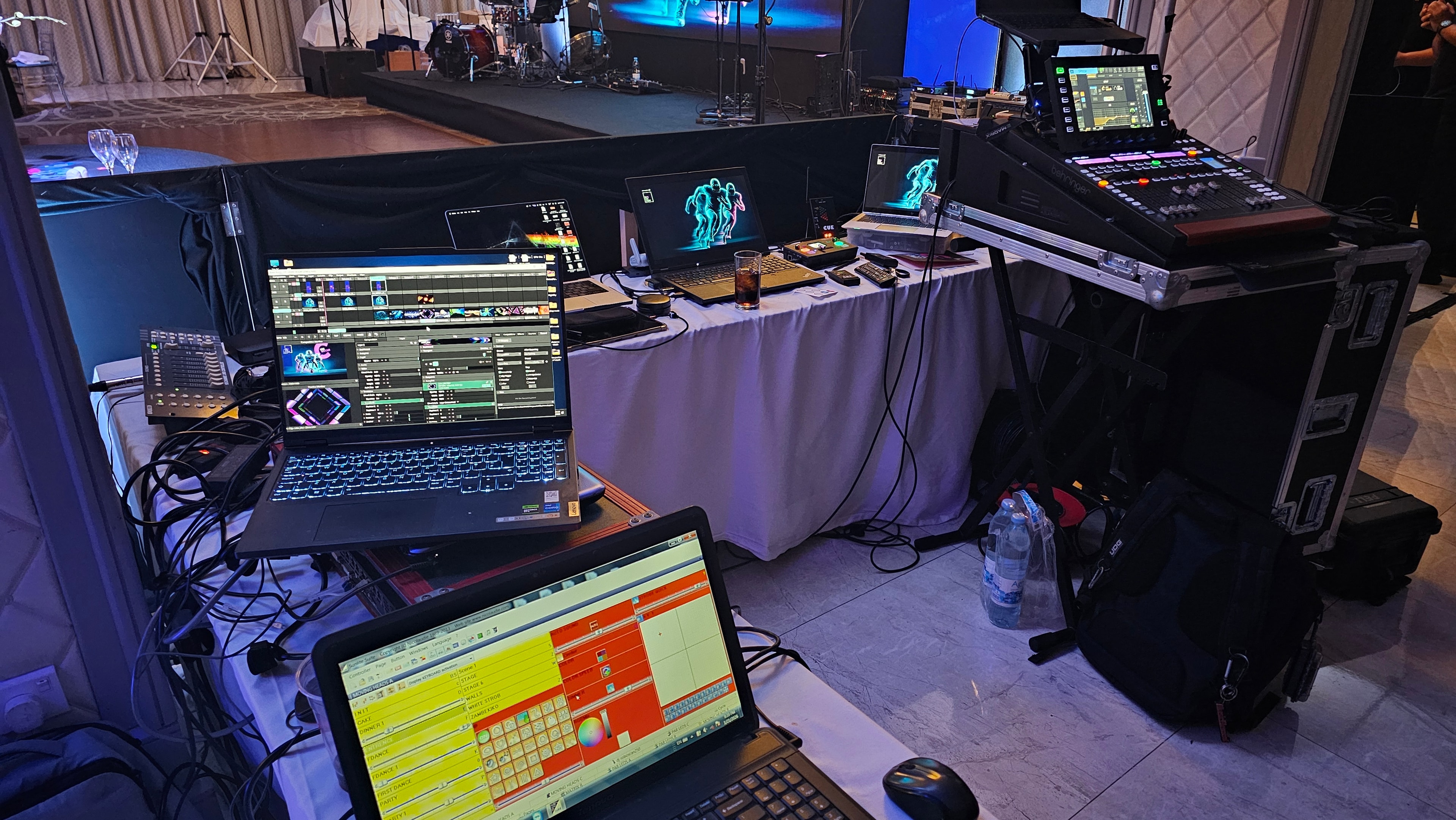 Event production control desk with audiovisual consoles and laptops