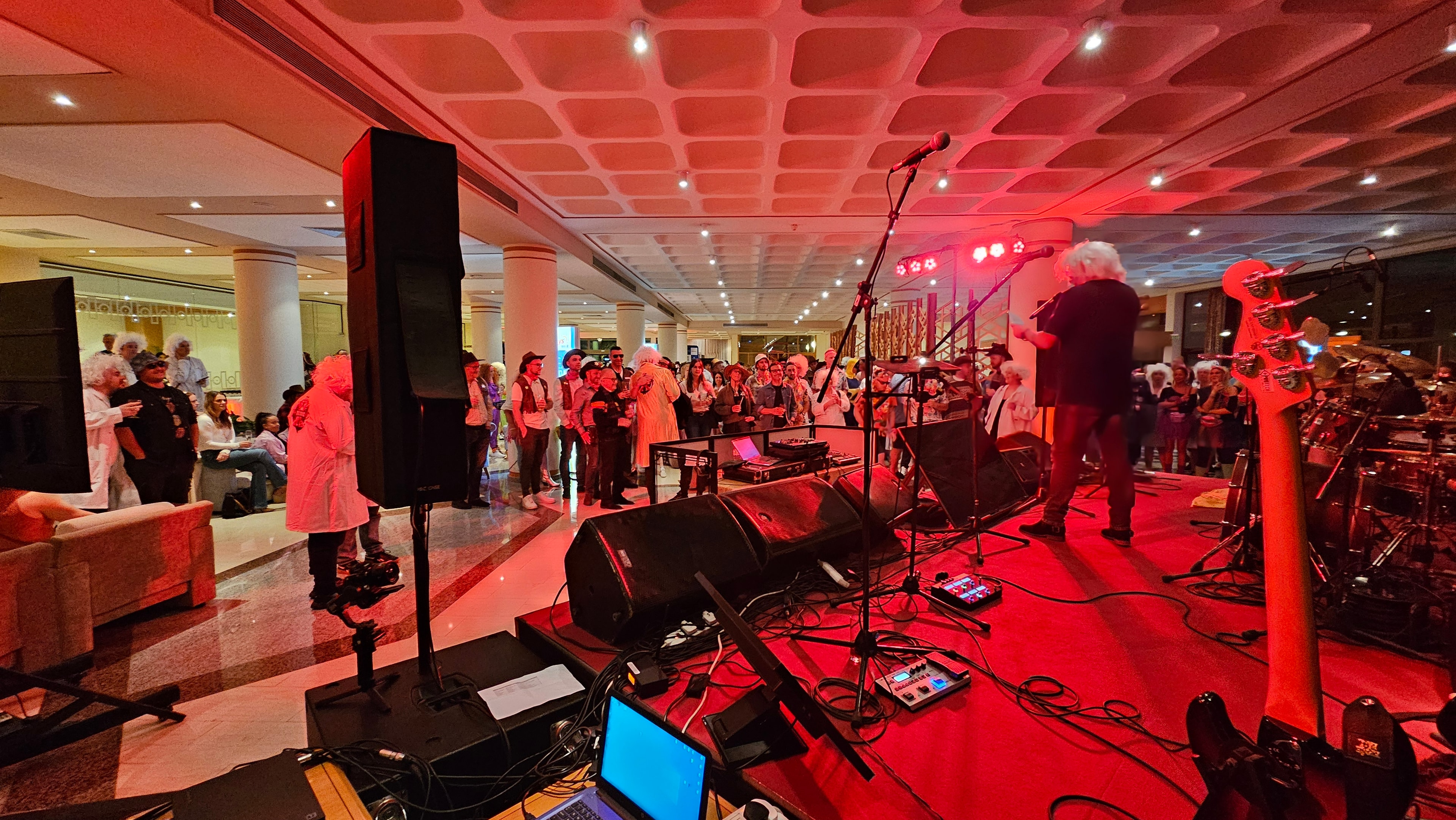 Side-stage view of the Time Machine performance area with band equipment and event lighting