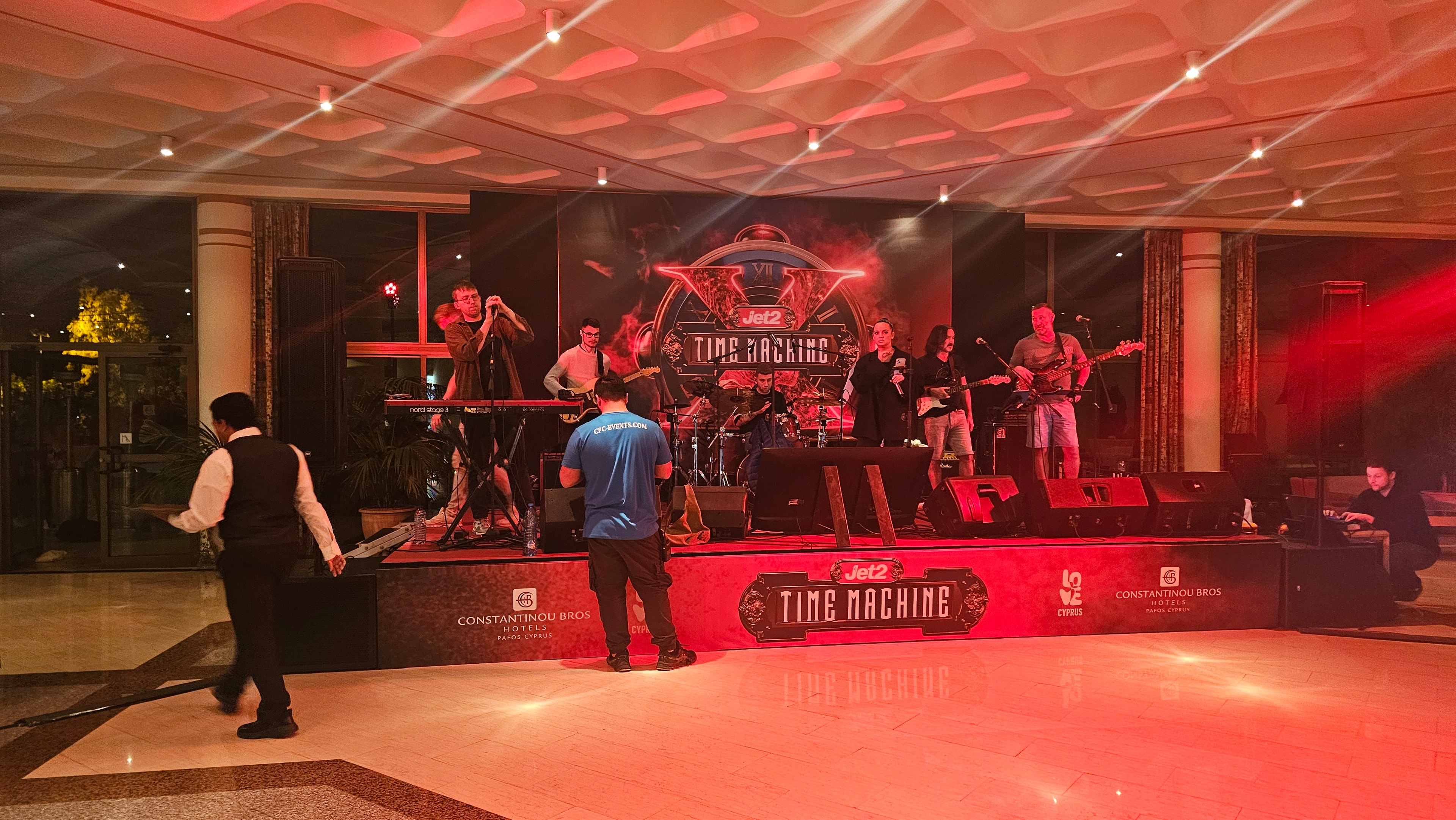 Wide view of the Time Machine-branded stage with speakers, lighting and performance equipment