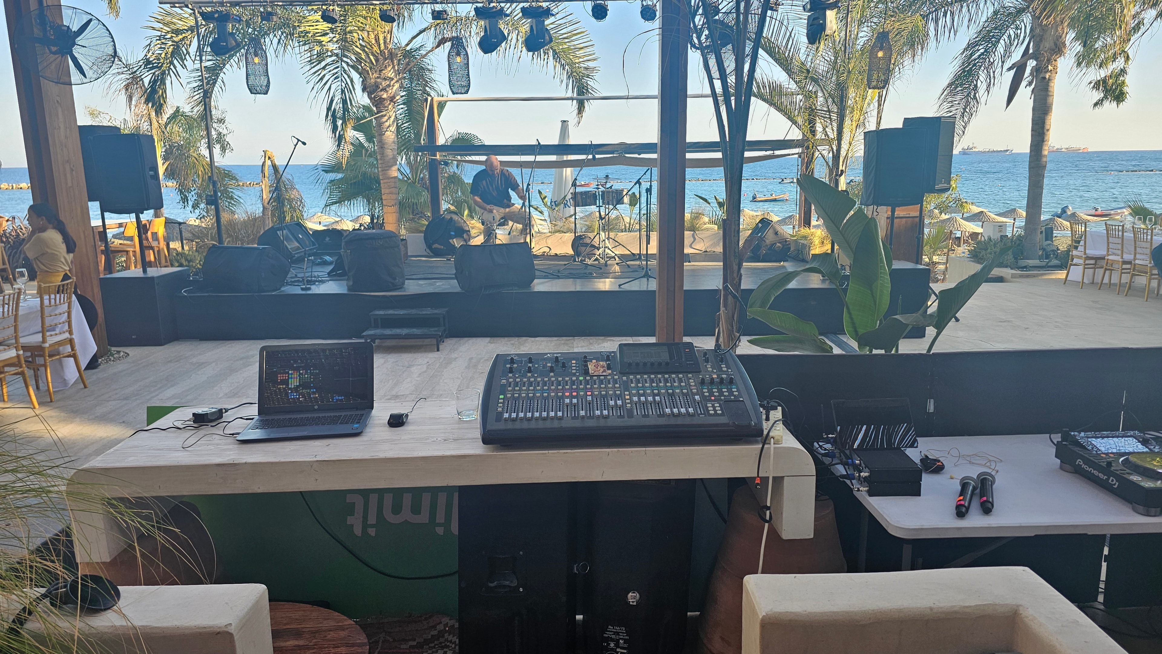 Beachside stage with live music equipment and sound control