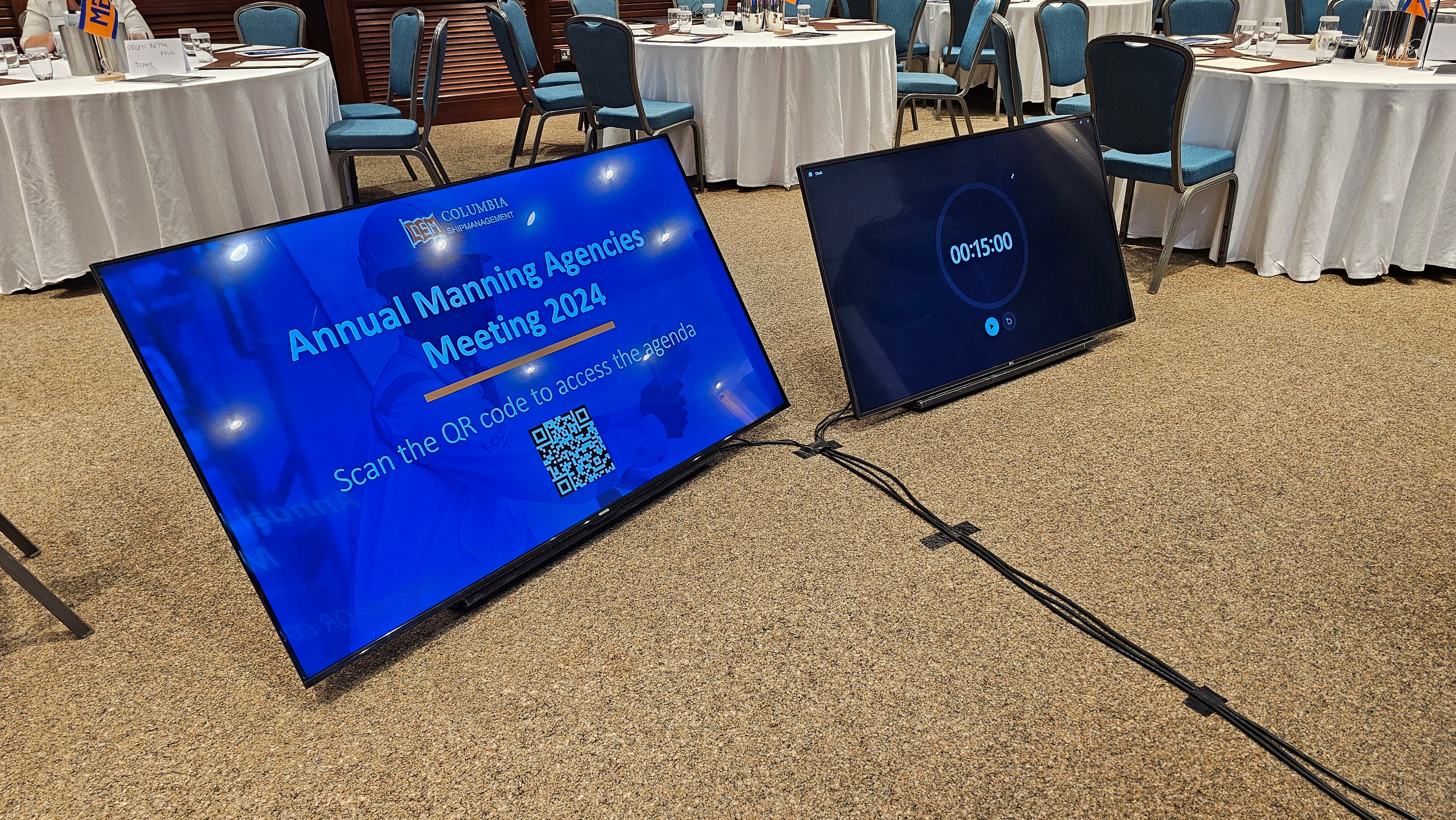 Floor monitors positioned in front of a conference presentation area