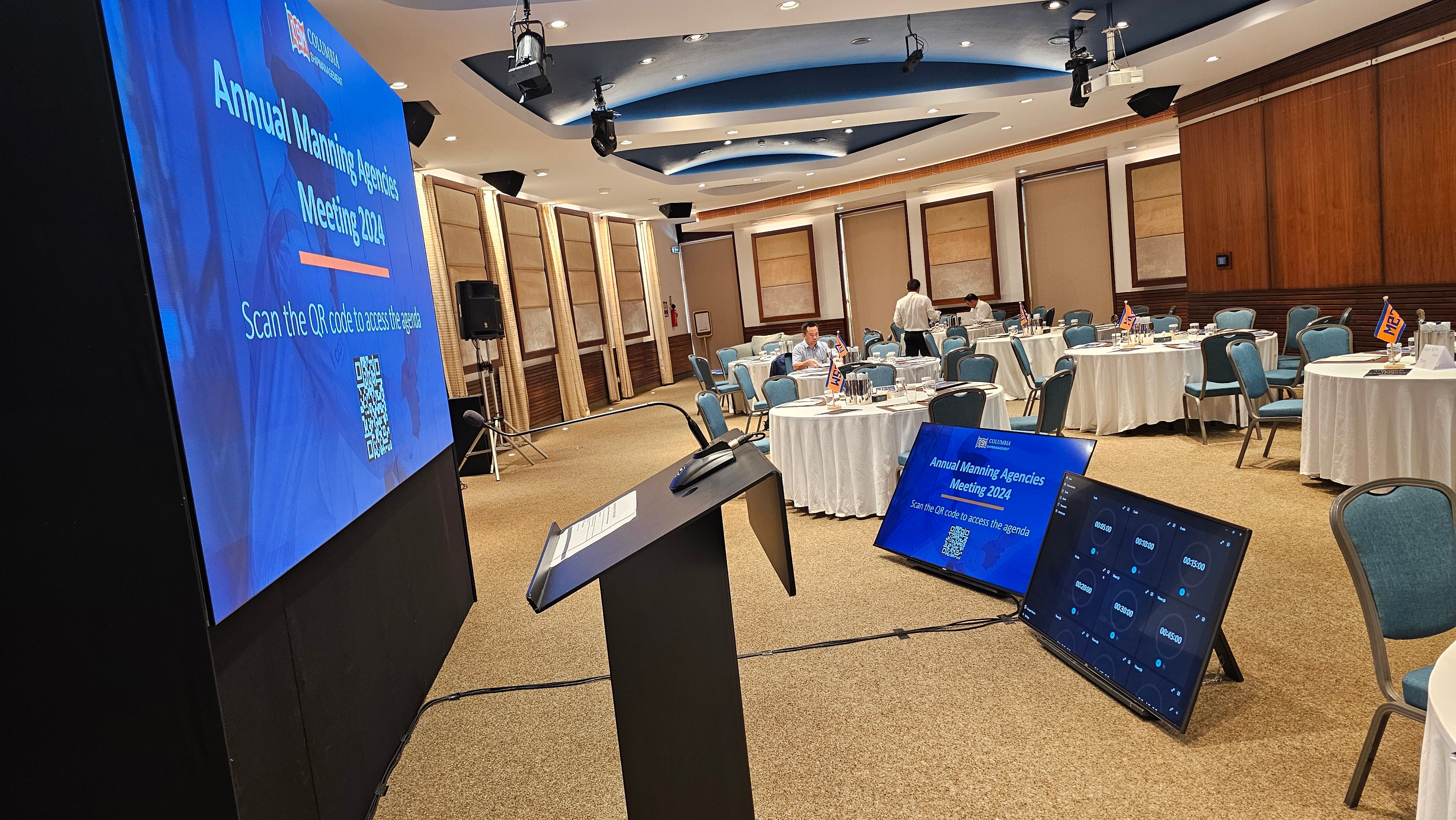 Lectern and projection screens in a Columbia Group conference room