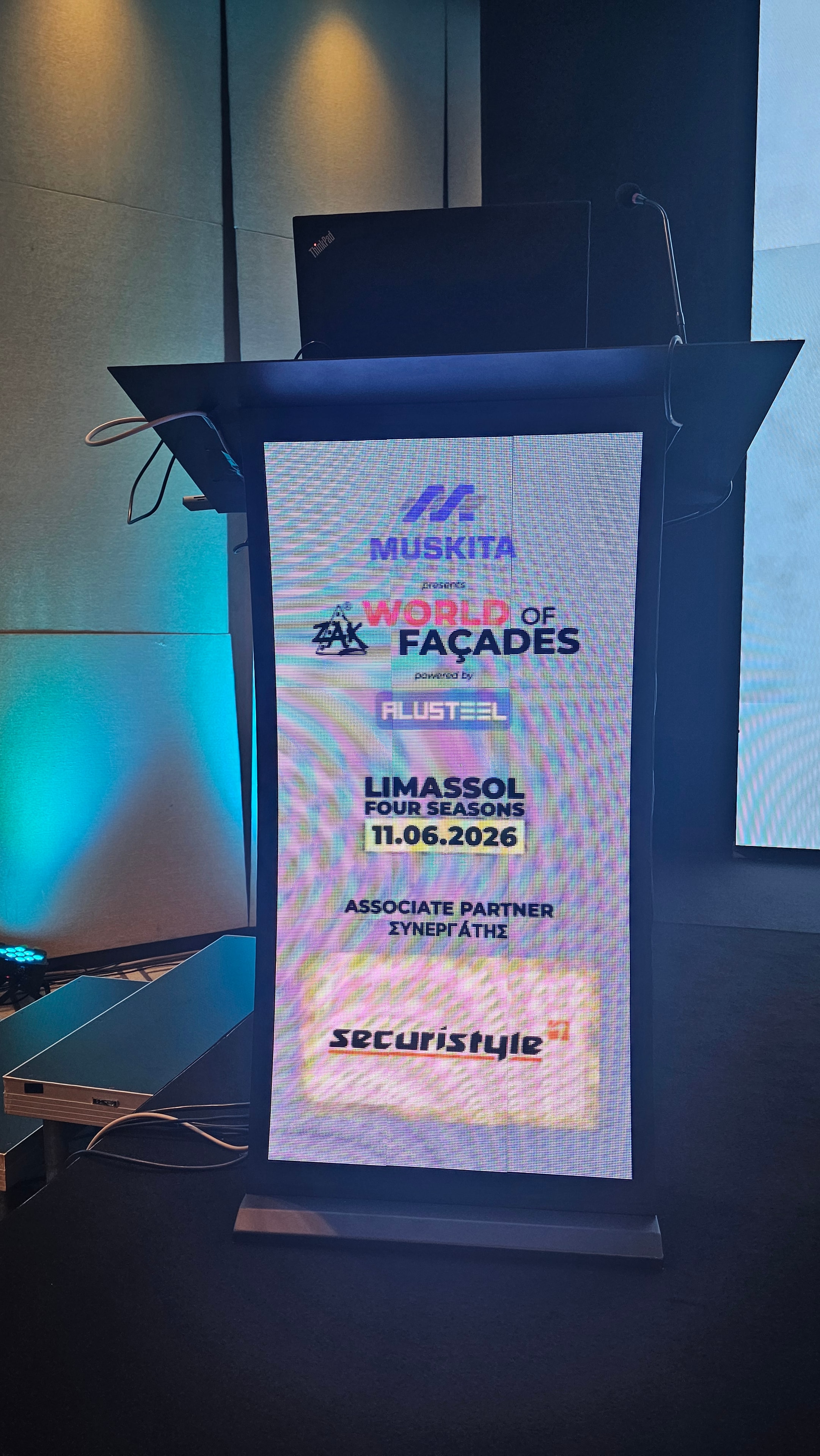 Digital lectern displaying the World of Façades event poster